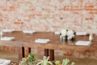 08 a narrow and tall concrete block wedding centerpiece filled with succulents