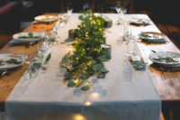 09 The wedding table setting was done with a neutral fabric runner, greenery, candles and LEDs