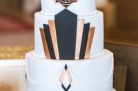 09 a white cake decorated with black and copper geo decor, a gold moon topper