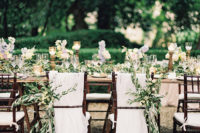 10 The wedding chairs were decorated with flowy fabric and greenery