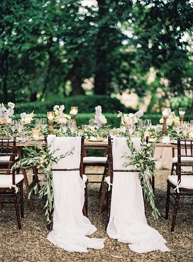 The wedding chairs were decorated with flowy fabric and greenery