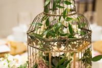 10 a metallic cage with foliage and lush florals for a beautiful wedding centerpiece