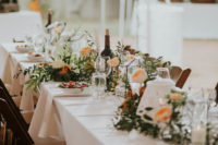 11 The wedding tablescape was done with geometric terrariums, peachy blooms and lots of greenery