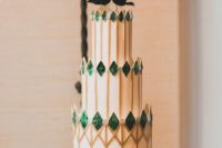11 a unique wedding cake with spiky emeralds, gold geo prints and black bird toppers