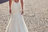 11 romantic mermaid wedding gown without sleeves, with a train and an illusion back with a row of buttons