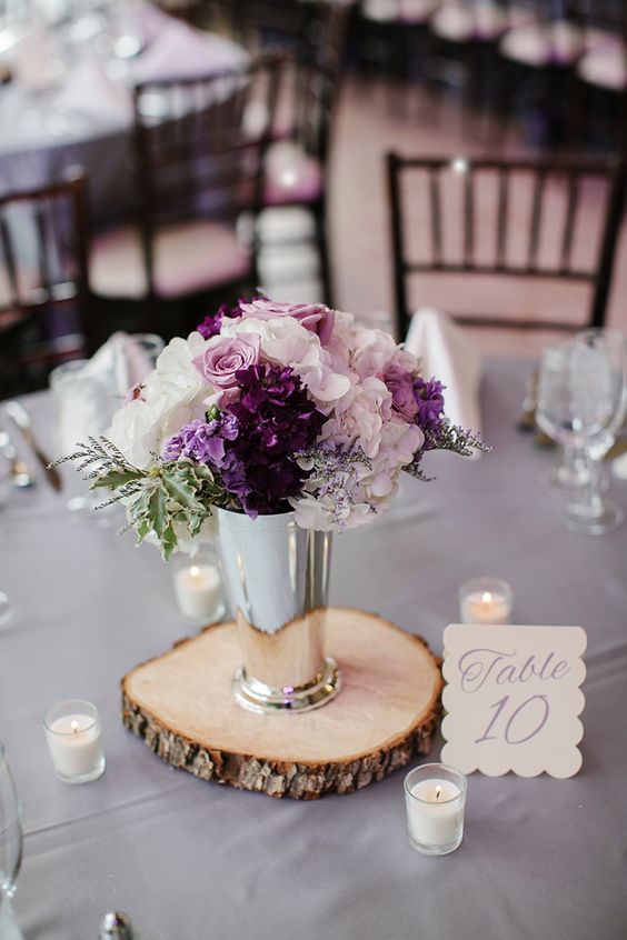 a chic floral arrangement with blush, white and purple blooms in a silver vase