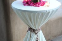 a cocktail table tied up with a rope and a tassel looks luxurious