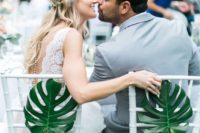 12 attach large tropical leaves to the couple’s chairs to highlight them