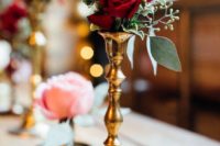 13 a gold candle holder with burgundy roses and greenery will be a nice decoration