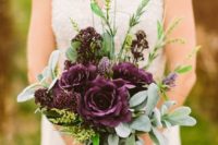 13 a moody fall bouquet with greenery and deep purple roses and blooms