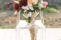 a cool and bold wedding bouquet with neutral tassels that decorated the wrap