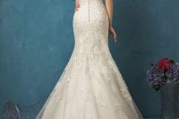 14 sleeveless mermaid lace wedding dress with an illusion back on buttons and a lace overskirt