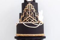 15 a chic black, gold and white wedding cake with gold geo decor, edible pearls and feathers