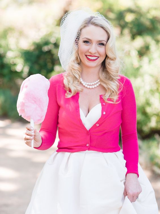 a hot pink cropped cardigan with long sleeves and a matching lipstick for a colorful wedding