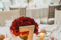 17 a red roses canterpiece and a glitter table number and candle holders are a timeless idea