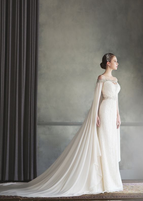 a stylish jeweled cape perfectly fits the wedding dress detailing