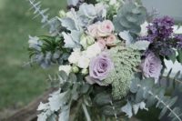18 a beautiful floral arrangement with pale eucalyptus, greenery and lilac and lavender blooms