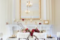 18 a refined wedding reception space with touches of red and gold and faux fur