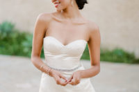 18 a short fitted peplum wedding dress with an embellished belt and modern jewelry