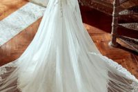 18 cap sleeve A-line overskirt wedding dress with a sheer and lace illuion back on buttons