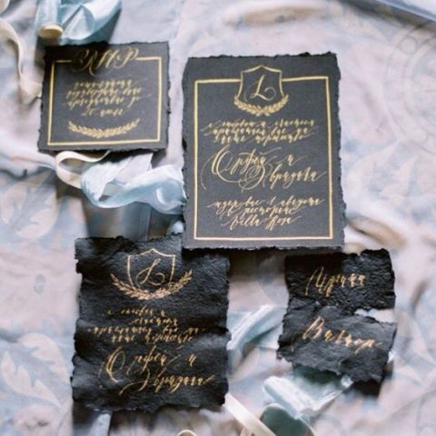 leather wedding invites with a raw edge and gold calligraphy