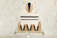 19 a square wedding cake with black and gold geometric decor