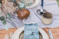 19 a wedding tablescape with indigo seating cards, candles and a light blue table runner