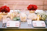 19 a wedding tablescape with white and gold glitter vases and red roses