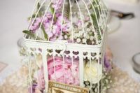 19 a white cage with lush florals of white, pink and lilac color for a sweet vintage wedding