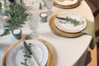 19 chic elf-inspired table with gold chargers, greenery, foliage and candles