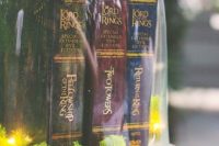 20 LOTR books in a cloche with LEDs and moss on a silver tray is an amazing centerpiece idea