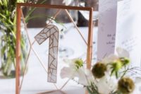 20 a glass copper number in framing and a glitter table number