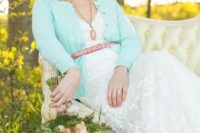 20 a mint cardigan with a pink leather belt for a chic and feminine bridal look