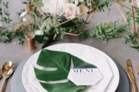20 a monstera leaf for each place setting for an industrial and modern wedding