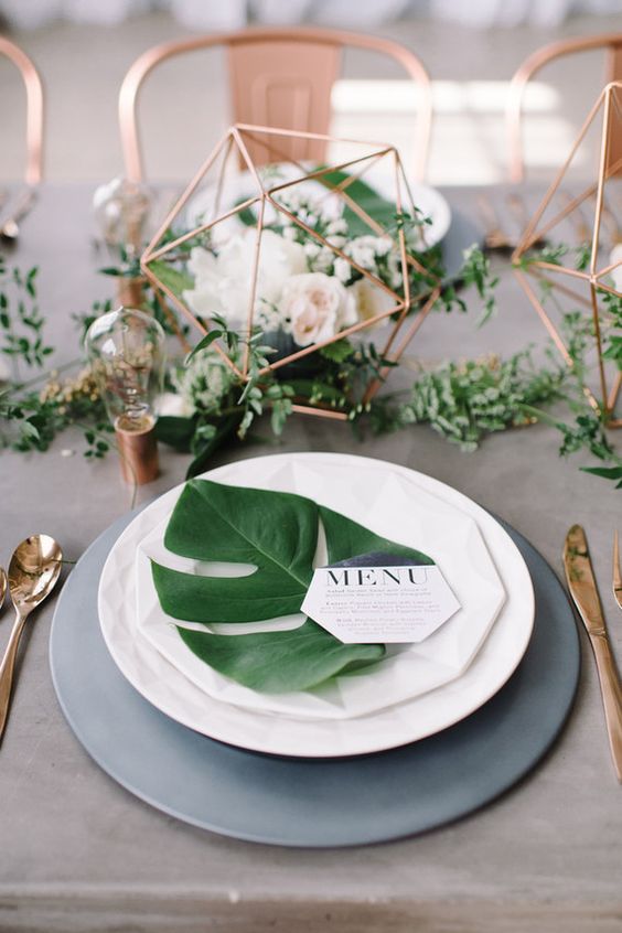 a monstera leaf for each place setting for an industrial and modern wedding