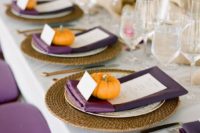 21 a fall table setting with purple napkins, menus and chairs, pumpkins for card holders