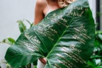 22 a stunning wedding menu with gold calligraphy on an oversized leaf