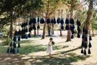 a wedding arch with oversized navy and blue tassels looks wow