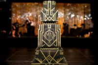 23 a square multi-layer black and gold wedding cake with geometric decor