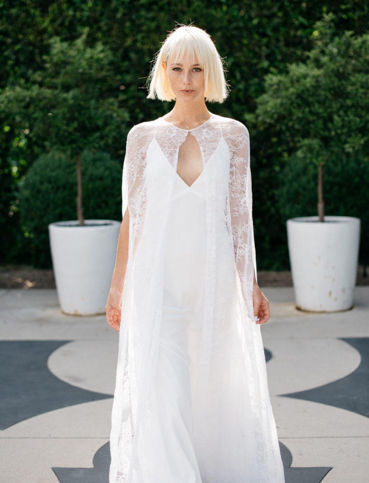 Ethereal lace cape looks amazing with a sleek minimalist spaghetti strap wedding gown