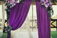 24 a wedding arch with purple curtains, hydrangeas and greenery