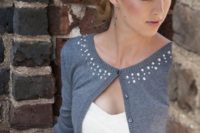 25 a strapless ballgown with a rhinestone sash and a short grey cardigan with half sleeves and the same rhinestones on the neckline