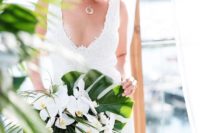 25 a wedding bouquet with palm leaves and white orchids looks wow