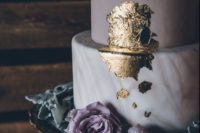 26 a matte lavender and a marble wedding cake topped with gold leaf and a pale lavender rose