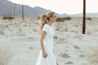 26 minimalist short sleeve wedding dress with a front slit and a high neckline