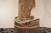27 a black and copper wedding cake with geo decor, scallops and feathers