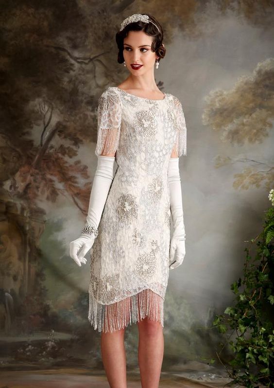 a short wedding dress with short fringed sleeves, with a fringed skirt and beading