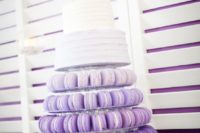 27 purple ombre macaron tower with a white two-tier wedding cake