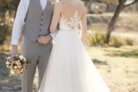 27 sleeveless A-line wedding dress with a tulle skirt and a lace applique illusion back with beaing