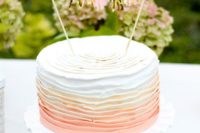 a tassel garland topper for a layered ombre cake looks cute and glam